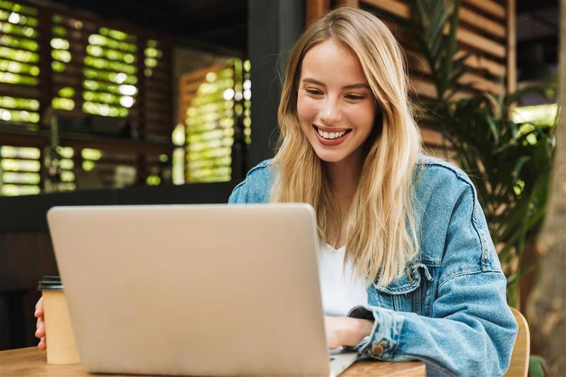 Junge blonde Frau am Computer